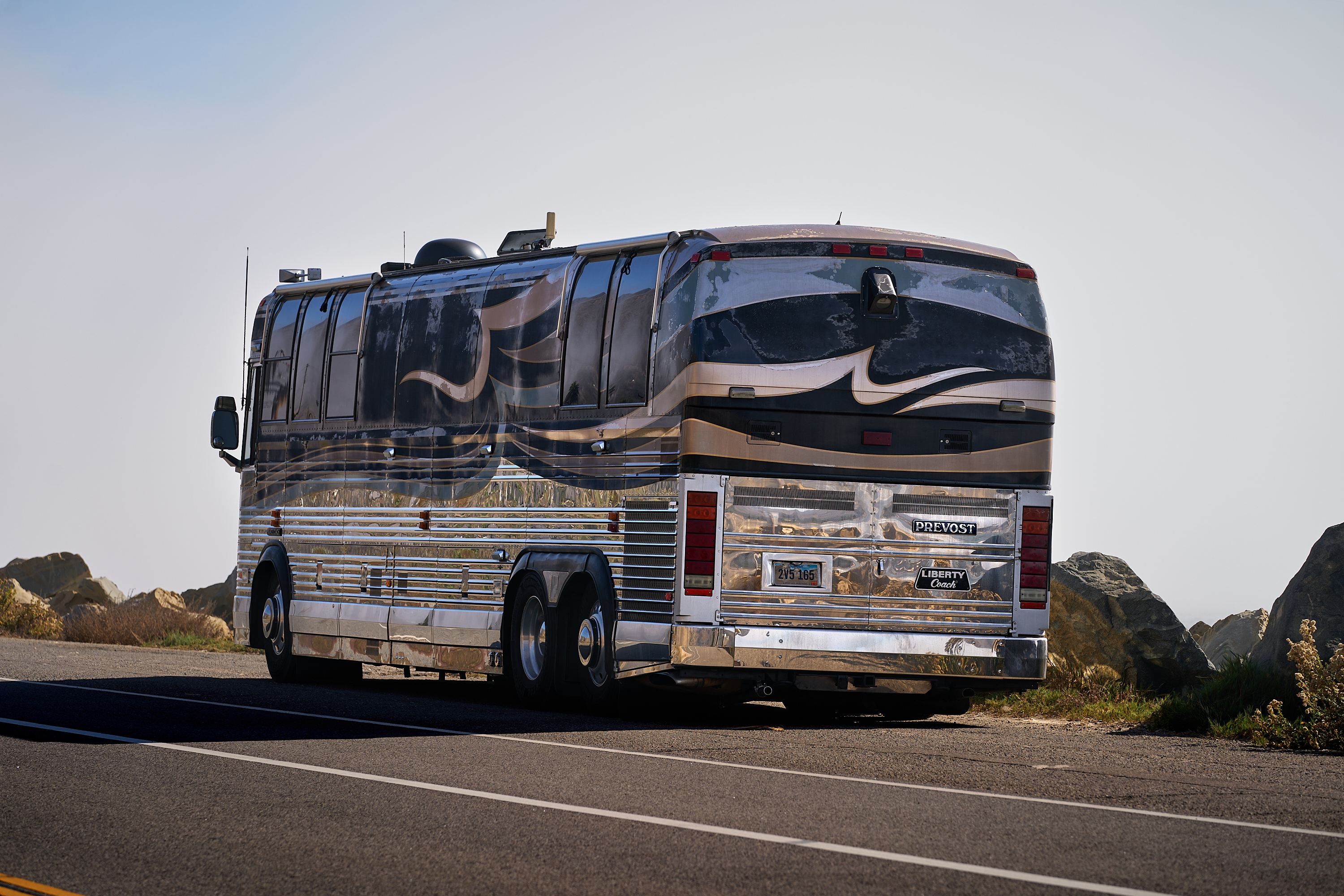 Vintage Tour Bus. American flag, RV, automotive, beach, beach umbrella, camper, camper van, dog, trailer, van conversion, vehicle, vintage trailer.