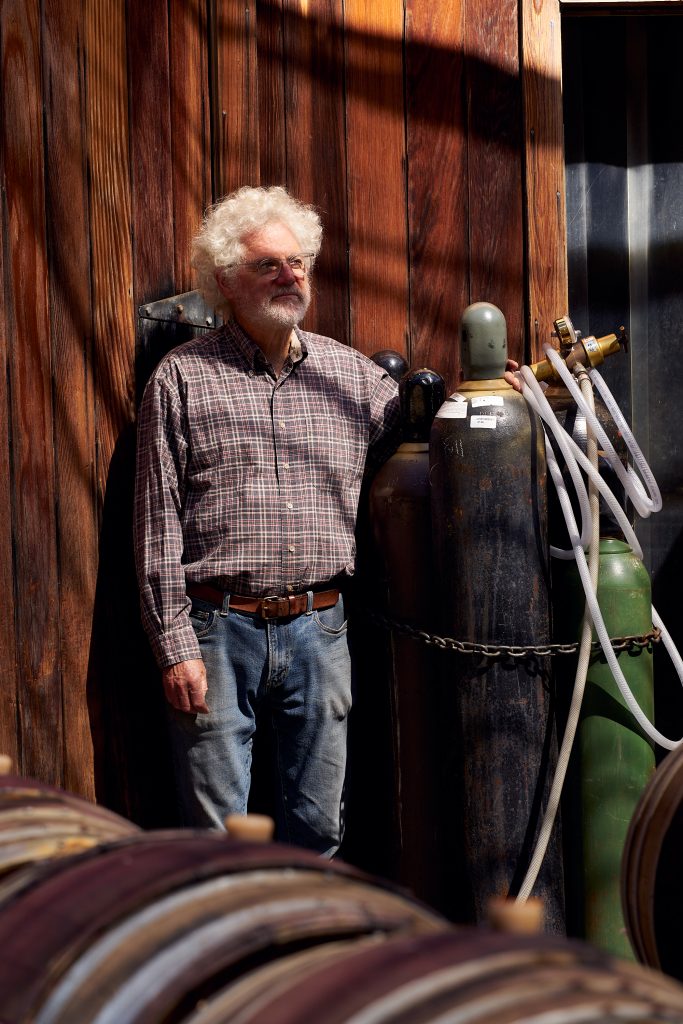 Wine Racking Process. farmer, Ojai Vinyard, Adam Tolmach, racking, vinyard, wine, wine barrels, wine racking, winemaking, portrait, ojai valley agriculture.
